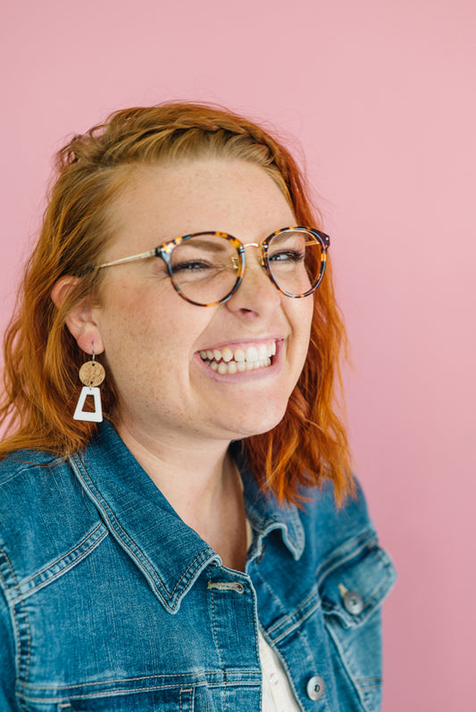 Cute Redhead girl looking super lighthearted and happy with her statement earrings on